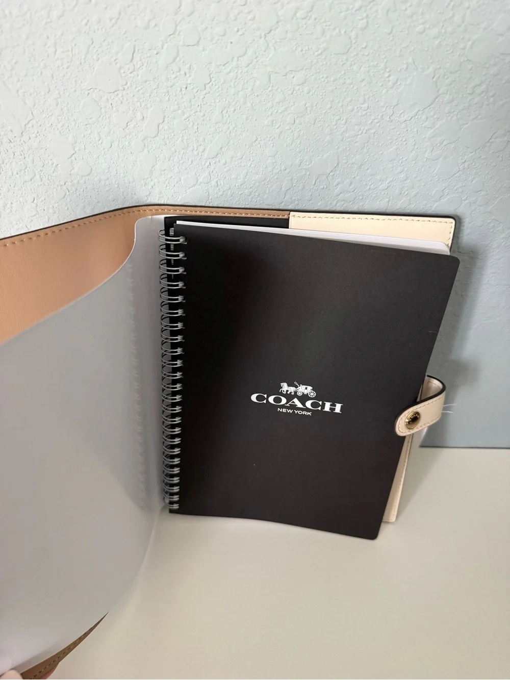 Brand new white coach notebook.